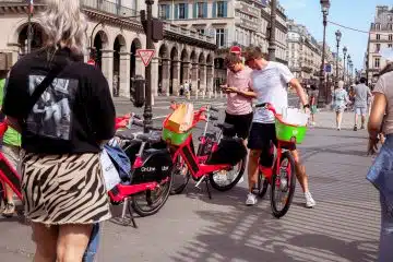 a couple of people that are standing next to some bikes