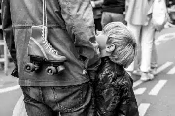 grayscale photo of boy in jacket